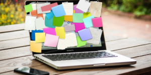 laptop covered in sticky notes 